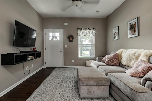 128 S Poplar St, Ottawa, KS 66067 - living room featuring dark wood-type flooring, a ceiling fan, and baseboards