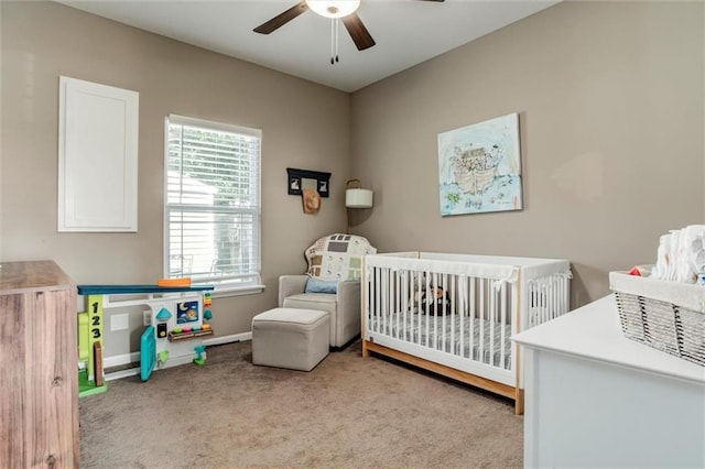 128 S Poplar St, Ottawa, KS 66067 - bedroom featuring carpet, a crib, baseboards, and a ceiling fan