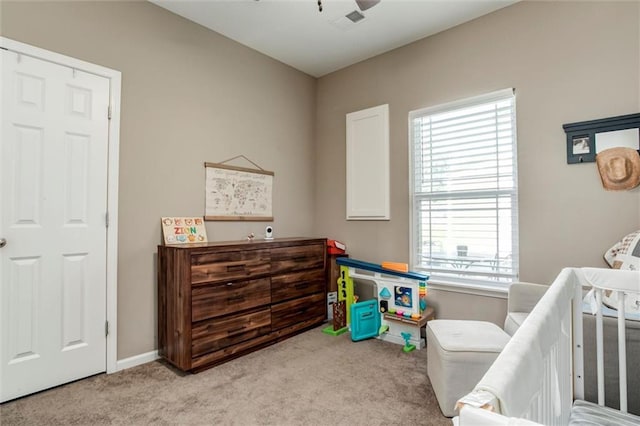 128 S Poplar St, Ottawa, KS 66067 - carpeted bedroom with multiple windows, baseboards, and ceiling fan