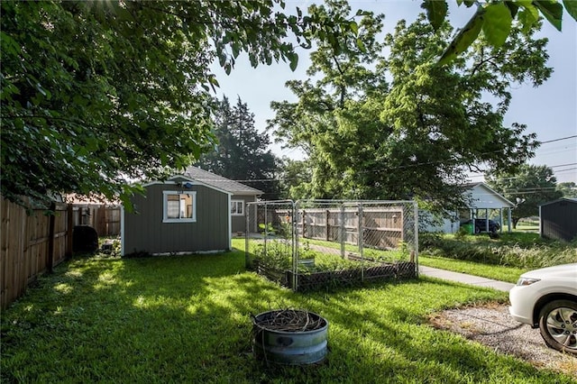 128 S Poplar St, Ottawa, KS 66067 - view of yard featuring a vegetable garden and an outbuilding
