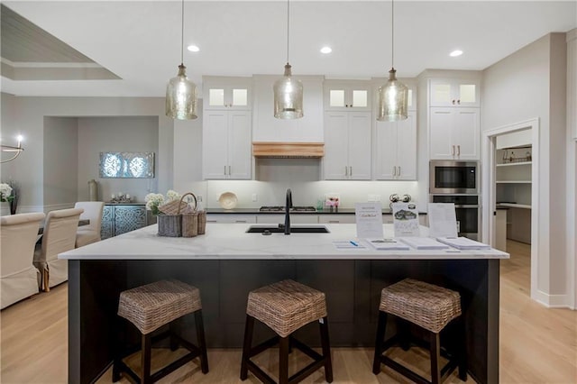 12507 W 183rd Ter, Overland Park, KS 66013 - kitchen with stainless steel appliances, white cabinetry, a sink, a breakfast bar area, and recessed lighting
