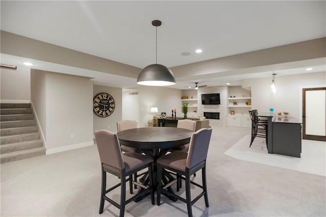 12507 W 183rd Ter, Overland Park, KS 66013 - dining room featuring light colored carpet, a fireplace, stairway, baseboards, and recessed lighting