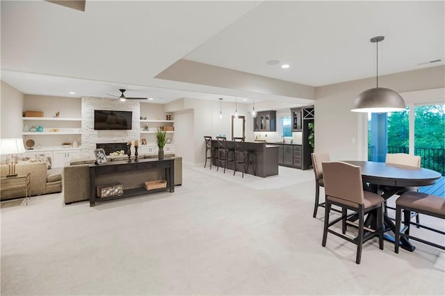 12507 W 183rd Ter, Overland Park, KS 66013 - living room featuring light colored carpet, a fireplace, ceiling fan, and recessed lighting