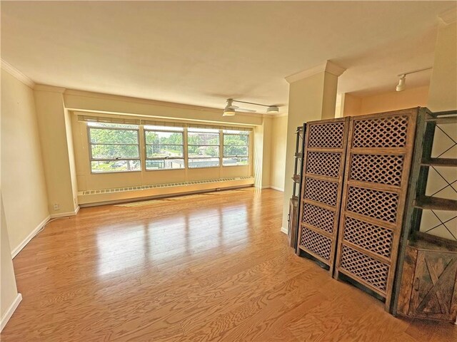 333 W Meyer Blvd Unit 414, Kansas City, MO 64113 - unfurnished room with a baseboard radiator, baseboards, plenty of natural light, and ornamental molding
