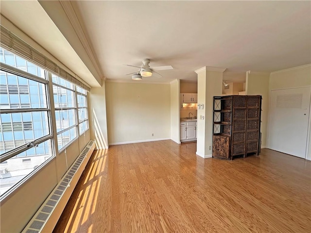 333 W Meyer Blvd Unit 414, Kansas City, MO 64113 - unfurnished living room with ornamental molding, light wood finished floors, ceiling fan, baseboard heating, and a sink