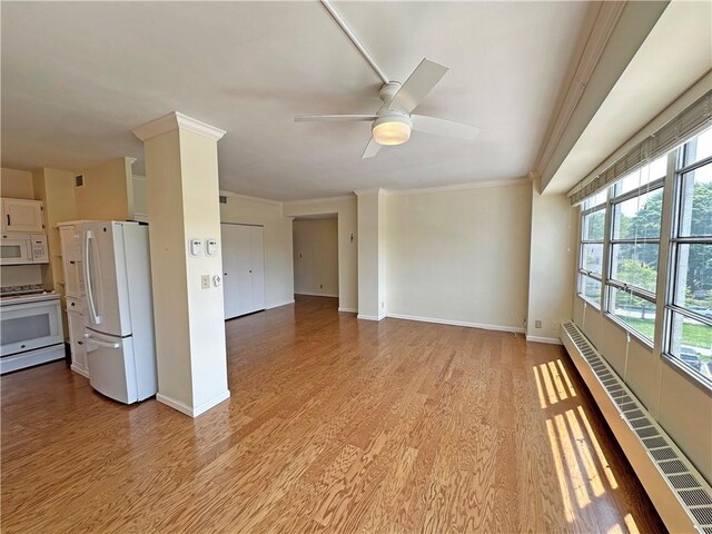 333 W Meyer Blvd Unit 414, Kansas City, MO 64113 - unfurnished living room with crown molding, ceiling fan, light wood-style flooring, a baseboard radiator, and plenty of natural light