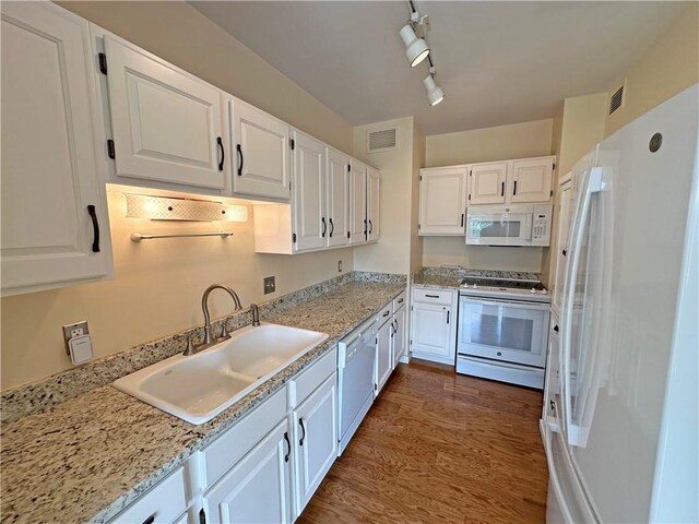 333 W Meyer Blvd Unit 414, Kansas City, MO 64113 - kitchen featuring white appliances, a sink, white cabinetry, dark wood-style floors, and track lighting