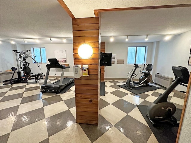 333 W Meyer Blvd Unit 414, Kansas City, MO 64113 - workout room with rail lighting, radiator heating unit, baseboards, and a textured ceiling