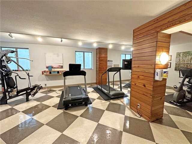 333 W Meyer Blvd Unit 414, Kansas City, MO 64113 - exercise room with rail lighting, baseboards, and a textured ceiling