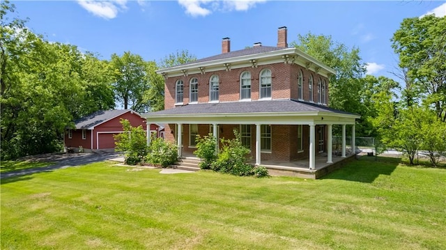 5322 SE Riverside Ter, Saint Joseph, MO 64507 - back of property featuring covered porch, a garage, an outbuilding, a chimney, and a yard