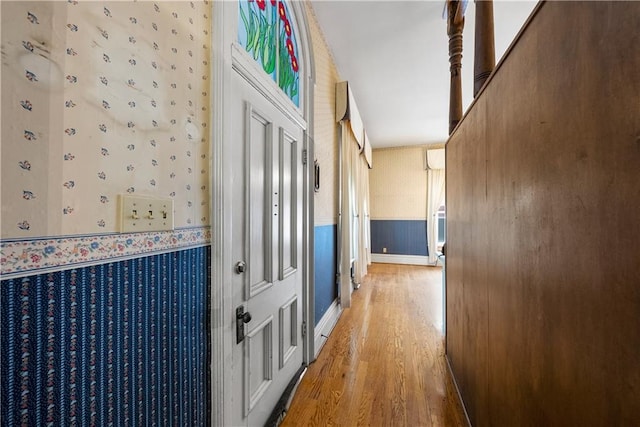 5322 SE Riverside Ter, Saint Joseph, MO 64507 - hall with wallpapered walls, light wood finished floors, and a wainscoted wall