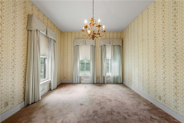 5322 SE Riverside Ter, Saint Joseph, MO 64507 - unfurnished dining area featuring a chandelier, carpet flooring, and wallpapered walls