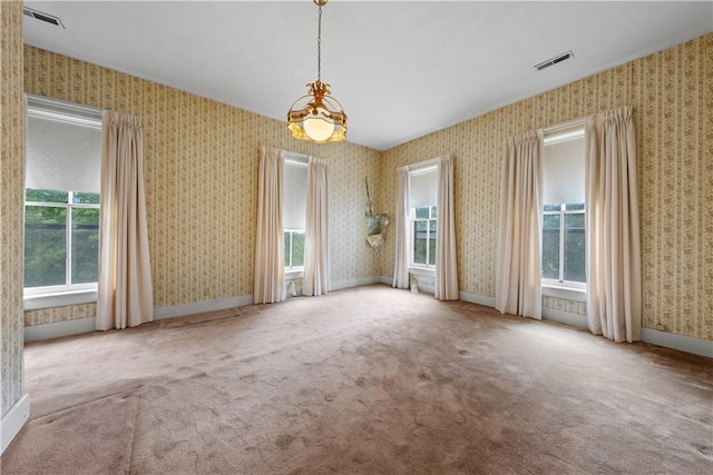 5322 SE Riverside Ter, Saint Joseph, MO 64507 - carpeted spare room featuring a chandelier and wallpapered walls