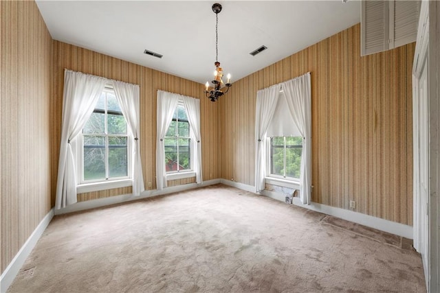 5322 SE Riverside Ter, Saint Joseph, MO 64507 - spare room with wallpapered walls, a chandelier, baseboards, and carpet