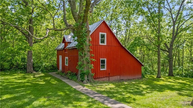 5322 SE Riverside Ter, Saint Joseph, MO 64507 - view of home's exterior featuring a barn, an outdoor structure, a yard, and metal roof