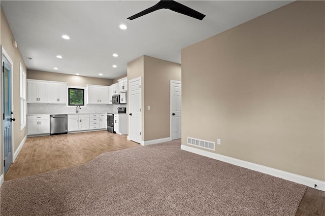 26696 235th St, Mclouth, KS 66054 - kitchen with stainless steel appliances, ceiling fan, open floor plan, baseboards, and light countertops