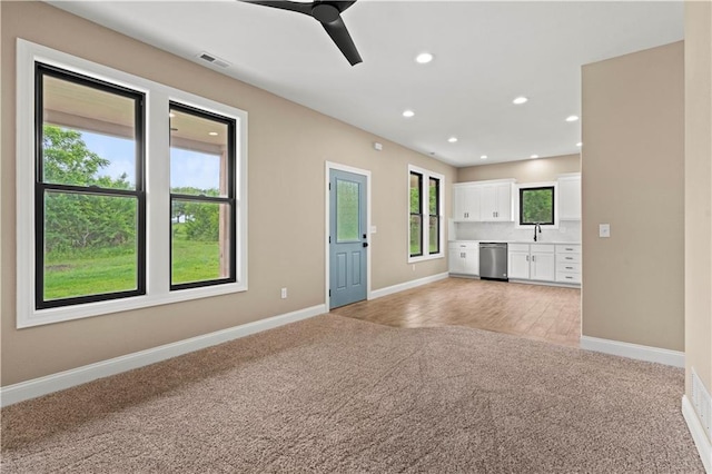 26696 235th St, Mclouth, KS 66054 - unfurnished living room featuring light carpet, baseboards, ceiling fan, a sink, and recessed lighting