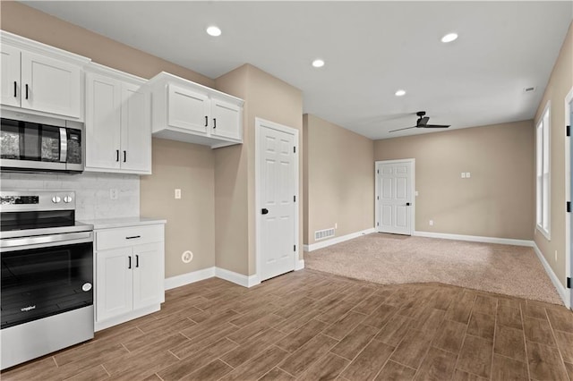 26696 235th St, Mclouth, KS 66054 - kitchen featuring appliances with stainless steel finishes, baseboards, ceiling fan, wood finished floors, and recessed lighting
