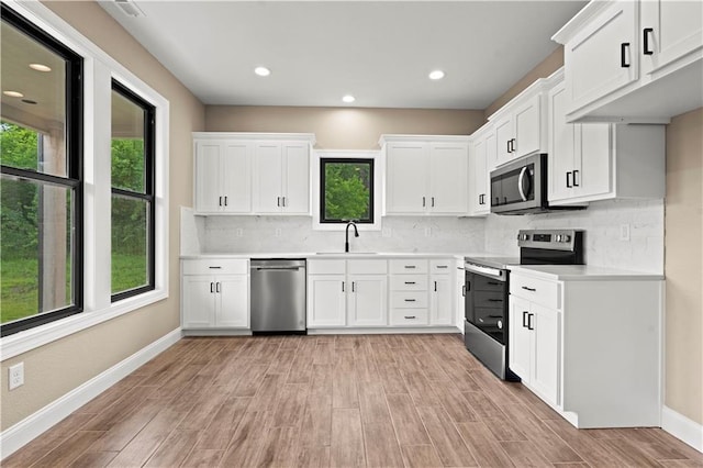 26696 235th St, Mclouth, KS 66054 - kitchen with stainless steel appliances, a sink, baseboards, light wood-type flooring, and recessed lighting