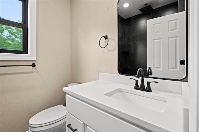 26696 235th St, Mclouth, KS 66054 - full bathroom featuring vanity, toilet, a textured wall, and a tile shower