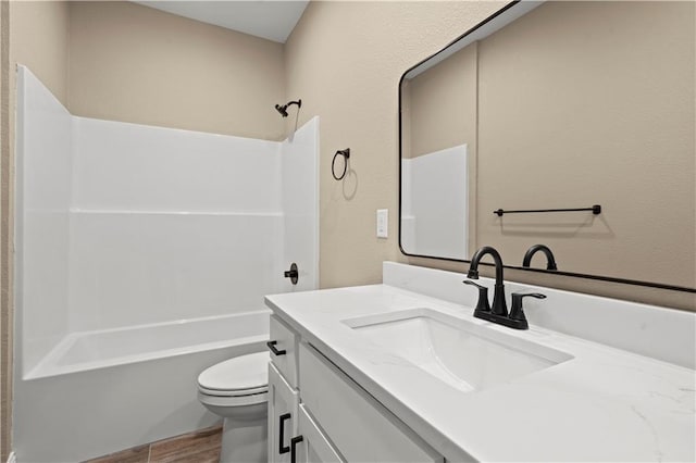 26696 235th St, Mclouth, KS 66054 - bathroom with vanity, toilet, shower / washtub combination, and wood finished floors