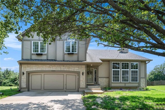 13511 W 56th Ter, Shawnee, KS 66216 - traditional-style house featuring stone siding, driveway, a front yard, an attached garage, and stucco siding