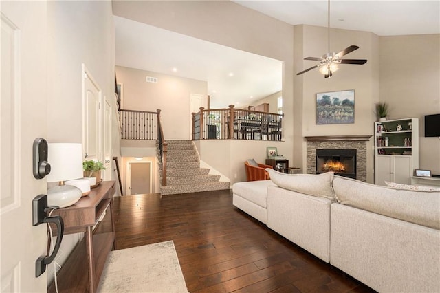 13511 W 56th Ter, Shawnee, KS 66216 - living area featuring dark wood finished floors, a ceiling fan, stairway, a glass covered fireplace, and recessed lighting