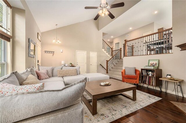 13511 W 56th Ter, Shawnee, KS 66216 - living room with high vaulted ceiling, stairway, a ceiling fan, wood-type flooring, and a chandelier