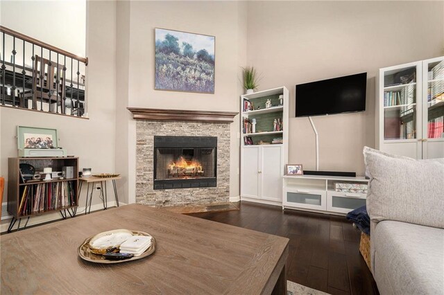 13511 W 56th Ter, Shawnee, KS 66216 - living area featuring dark wood-type flooring, a towering ceiling, and a fireplace