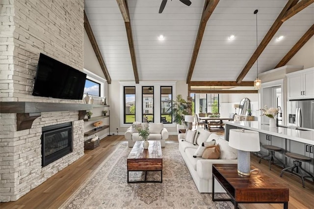 3053 NW Thoreau Ln, Lees Summit, MO 64081 - living area featuring light wood-style floors, a fireplace, ceiling fan, and recessed lighting