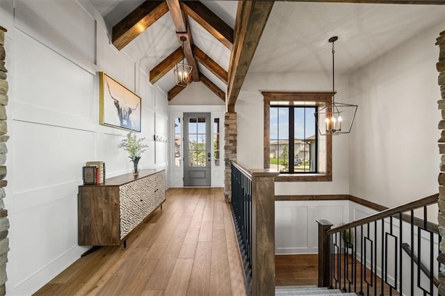 3053 NW Thoreau Ln, Lees Summit, MO 64081 - entryway featuring a chandelier, hardwood / wood-style flooring, a decorative wall, and a wainscoted wall