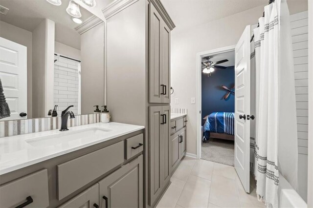 3053 NW Thoreau Ln, Lees Summit, MO 64081 - ensuite bathroom with vanity, tile patterned floors, a ceiling fan, and shower / tub combo