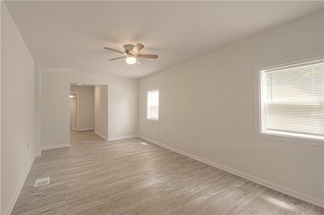 3874 E 63rd St, Kansas City, MO 64130 - empty room with a ceiling fan and light wood-style flooring