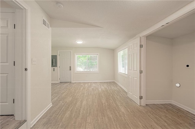 3874 E 63rd St, Kansas City, MO 64130 - hall featuring vaulted ceiling, light wood finished floors, and a textured ceiling