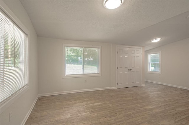 3874 E 63rd St, Kansas City, MO 64130 - empty room featuring wood finished floors and a textured ceiling