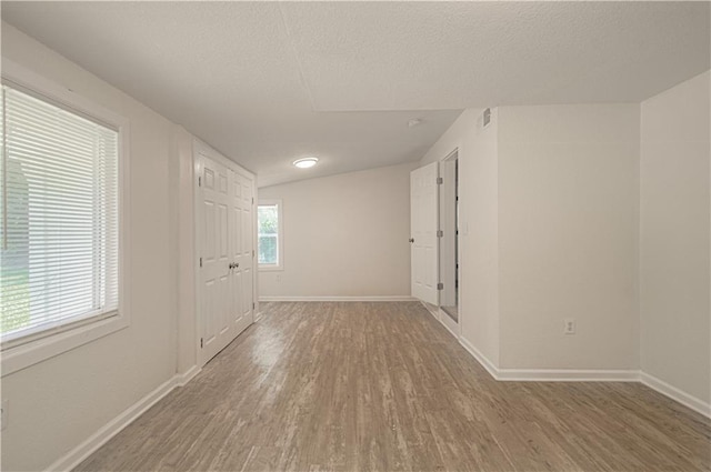 3874 E 63rd St, Kansas City, MO 64130 - unfurnished room featuring wood finished floors and a textured ceiling