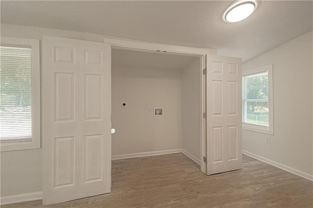 3874 E 63rd St, Kansas City, MO 64130 - laundry area with washer hookup, electric dryer hookup, a textured ceiling, and light wood finished floors