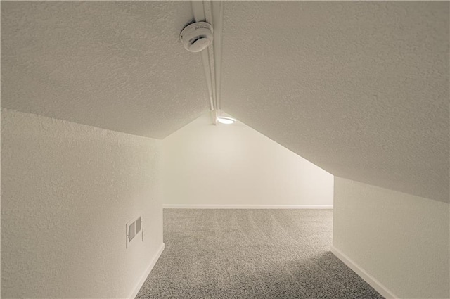 3874 E 63rd St, Kansas City, MO 64130 - bonus room with a textured ceiling, carpet, and lofted ceiling