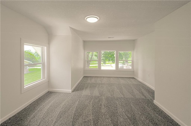 3874 E 63rd St, Kansas City, MO 64130 - empty room with carpet flooring and a textured ceiling
