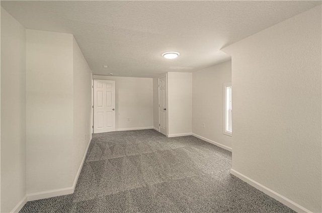 3874 E 63rd St, Kansas City, MO 64130 - carpeted spare room with a textured ceiling