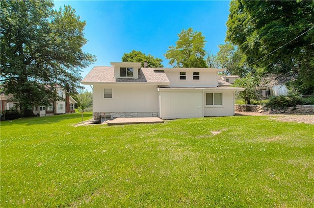 3874 E 63rd St, Kansas City, MO 64130 - rear view of house featuring a lawn, a patio area, and a shingled roof