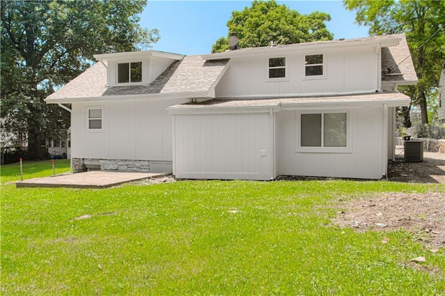 3874 E 63rd St, Kansas City, MO 64130 - back of house with a shingled roof, a lawn, and a patio area