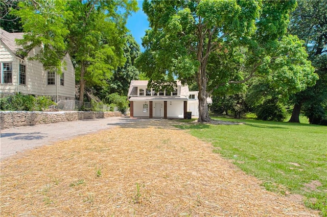 3874 E 63rd St, Kansas City, MO 64130 - view of grassy yard with driveway and view of scattered trees