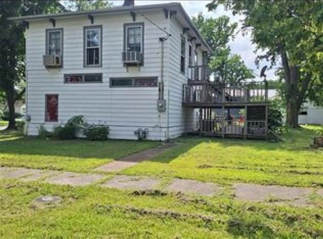 230 E Prairie, Girard, KS 66743 - rear view of property featuring a lawn, a deck, and cooling unit