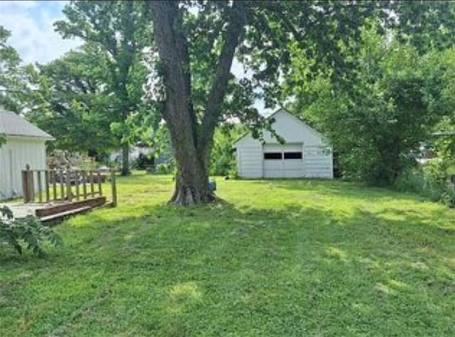 230 E Prairie, Girard, KS 66743 - view of green lawn featuring a garage and an outbuilding