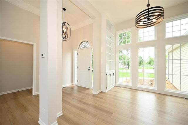 18 Timber Creek Cir, Platte City, MO 64079 - entryway featuring a chandelier, wood finished floors, ornamental molding, baseboards, and a high ceiling