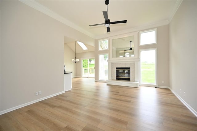 18 Timber Creek Cir, Platte City, MO 64079 - unfurnished living room with ornamental molding, ceiling fan, light wood-type flooring, a chandelier, and a tiled fireplace