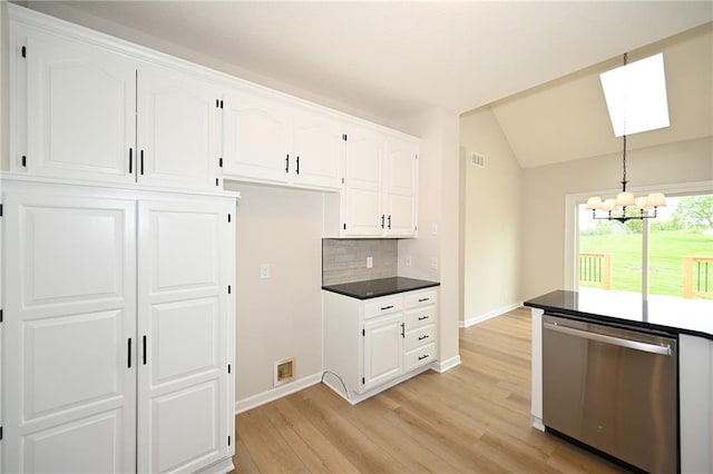 18 Timber Creek Cir, Platte City, MO 64079 - kitchen with stainless steel dishwasher, a chandelier, baseboards, white cabinetry, and lofted ceiling