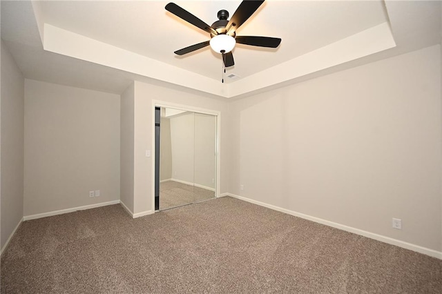 18 Timber Creek Cir, Platte City, MO 64079 - unfurnished bedroom with a tray ceiling, carpet, baseboards, and a closet