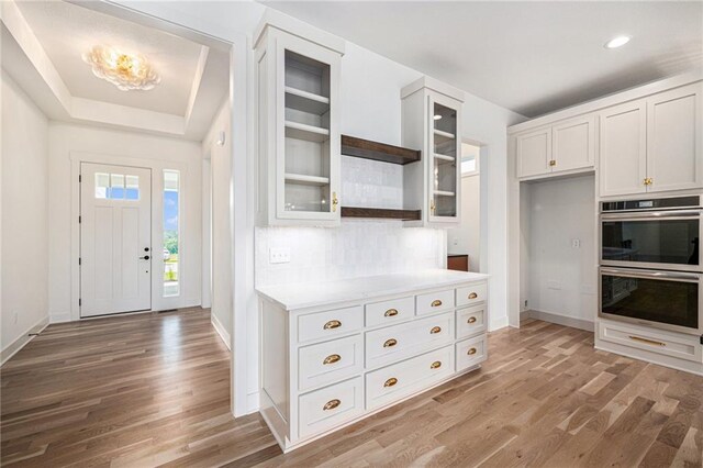 12445 Empress St, Platte City, MO 64079 - kitchen featuring stainless steel double oven, open shelves, light wood-style flooring, baseboards, and recessed lighting